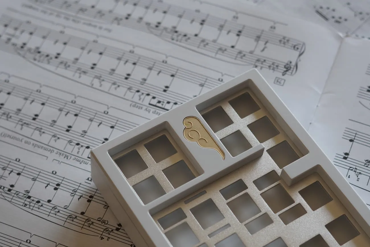 Brass plate and brass cloud badge resting on sheet music.